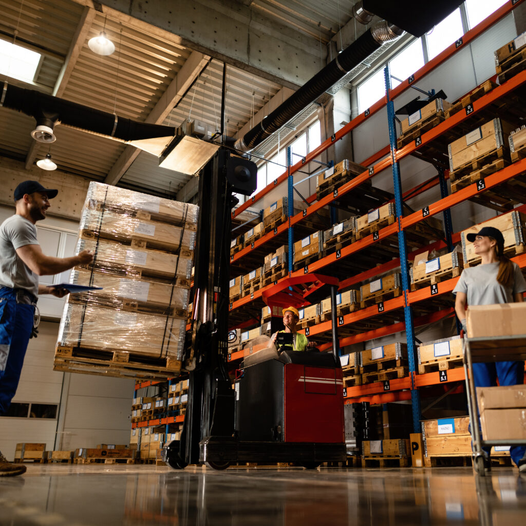 Below view of group of workers cooperating in a warehouse.